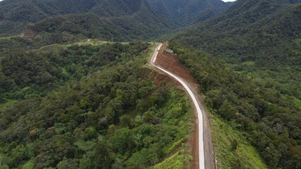 Aerial rural road winding through a mountainous landscape