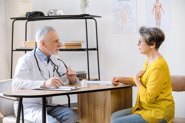 elderly patient woman talking with doctor at appointment