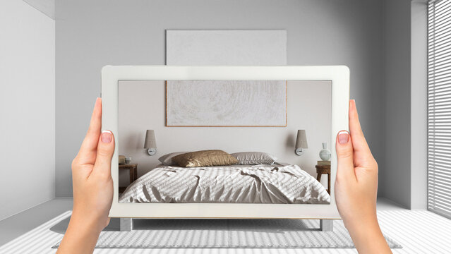 Augmented reality concept. Hand holding tablet with AR application used to simulate furniture and design products in total white unfinished background, minimal bedroom