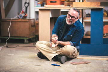 Senior Caucasian Foreman has an Accident while Working in Wood Factory, Concept of First Aids, Safety and Insurance in Workplace.