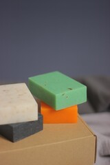 Close-up of four soaps neatly stacked on top of rectangular boxes