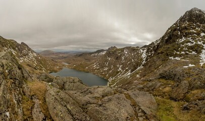 Fototapeta na wymiar View from the ascent to the summit of Yr Wyddfa in Snowdonia, Wales against a clouded sky