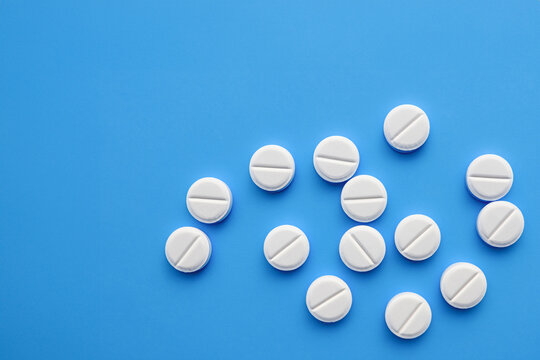 Pills on a blue, medical background