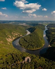 Scenic view of a river winding through a mountainous landscape in Saarland, Germany