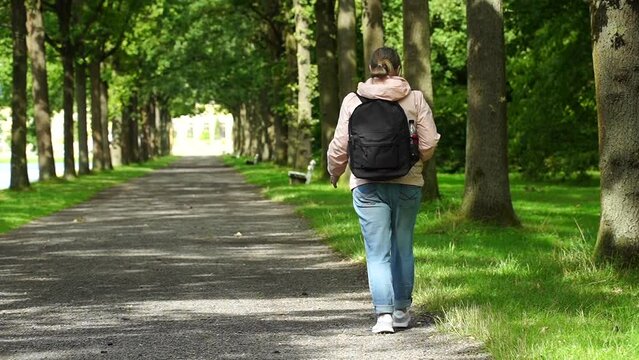 01.08. 2023, Kassel, Germany. Young middle-aged woman with casual clothes. Adidas sneakers and jeans