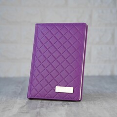 Purple passport cover on a wooden table surface.