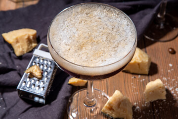 Parmesan Cheese Espresso Martini Cocktail, cheesy whipped coffee drink in martini glass with grated...