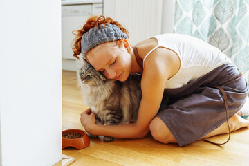 Favorite pet Maine Coon cat and his mistress at home