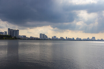Fototapeta premium Hanoi, Vietnam - July 10, 2023: Gazing across West Lake, reflection of the sky on its waters, stands the Tran Quoc Pagoda, a captivating tourist attraction and destination of sublime beauty