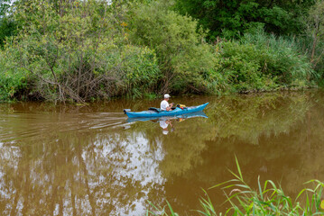 Kayaker Paddling On The River In Summer