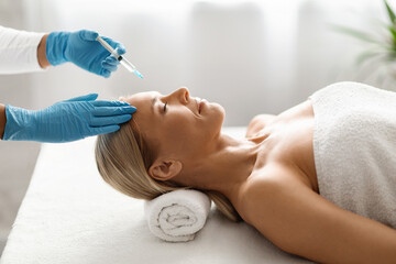 Attractive Middle Aged Woman Having Injection Cosmetology Session At Spa Salon