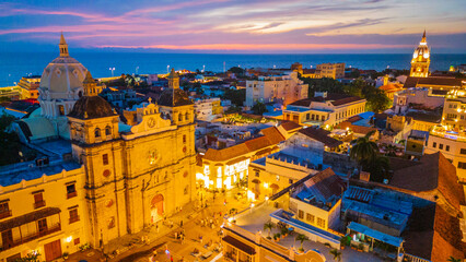 Fototapeta premium Cartagena, Colombia. Aerial View of Santuario de San Pedro Claver Church at Night, Traffic and Neighborhood, Drone 