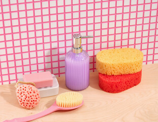 Bathing products. Colored shower sponges, thick bristle brush, pink soap, dispenser with liquid...