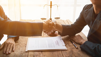 Fototapeta na wymiar Legal consultant and businessman shake hand inside lawyer office to show mutual agreement to be legal advisor for businessman investment firm Collaboration. concept businessman and legal consultant