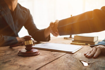 Legal consultant and businessman shake hand inside  lawyer office to show mutual agreement to be legal advisor for businessman investment firm Collaboration. concept businessman and legal consultant - obrazy, fototapety, plakaty