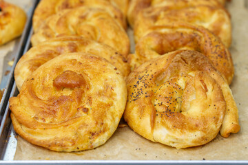 Baking from puff pastry, Vertuta or placinda. Appetizing pastries. Fast food. Snack from the bakery for a break.