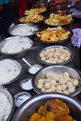 sweets for indian hindu marriage, gulab jamun, cashew katli and snacks placed in steel plate