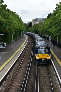 GREENWICH  UK  JUNE 2022   YELLOW LONDON OVERGROUND ARRIVING TO GREENWICH STATION  