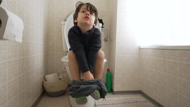 Childhood Potty Training Concept, Small Boy Sitting on Toilet Learning Hygiene and Independence in Bathroom