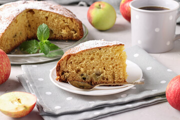 Piece homemade apple pie and cup of coffee on gray background