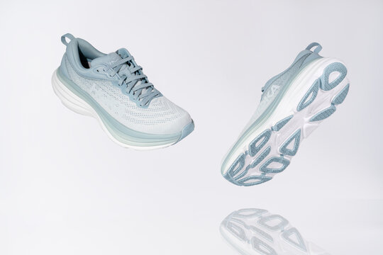 Strasbourg, France - August 2023 : Hoka Bondi 8 new green running shoes on white background antigravity and reflection. Stylish monochrome shoes for active people that incorporate new health