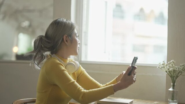 Asian university female millennials or generation z using smart phone.