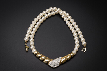 Vintage pearl necklace with diamond studded pendant on rope gold On a stone background and thought to date around 1890&rsquo;s