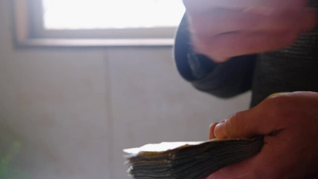 man holding, counts lot of national currency of Sri Lanka, paper money bills Rupee banknotes, devaluation, high inflation of state, exchange rate on travel, vacation, savings, banking, tax payment