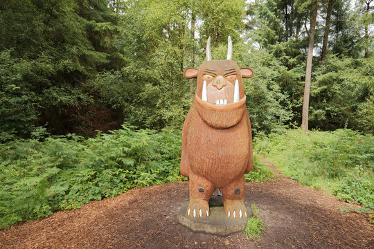 Dalby Forest, North Yorkshire, UK - 08 02 2023: A wooden statue of the Gruffalo stands in a forest. Julia Donaldson and Axel Scheffler wrote the children's picture book story in 1999.