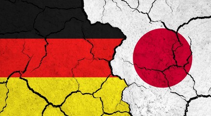 Flags of Germany and Japan on cracked surface - politics, relationship concept