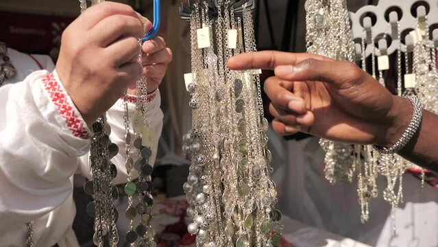 Man buying typical baltic jewelleries on little market (Estonia)