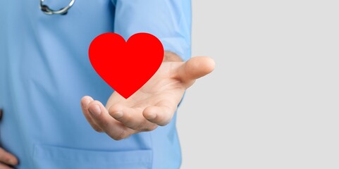 Young doctor holding Heart in hand.