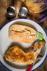 Fried chicken leg with bread roll.