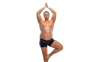 A funny fat man isolated on white background doing yoga practice. Obesity and eating disorder....