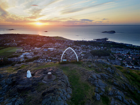 Aerial view of the whale bone monument on top North Berwick law in Scotland at sunset