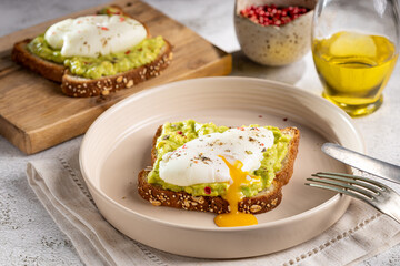 Wholemeal toast with avocado and poached egg.