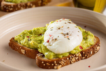 Wholemeal toast with avocado and poached egg.
