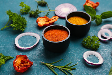 Composition with spices, dried tomatoes and herbs on color background