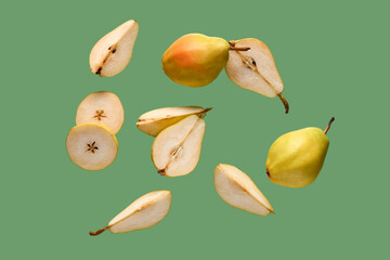 Flying fresh pears on green background
