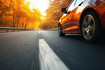 Foto op Canvas car on the road in the autumn forest. speed motion blur effect © artem