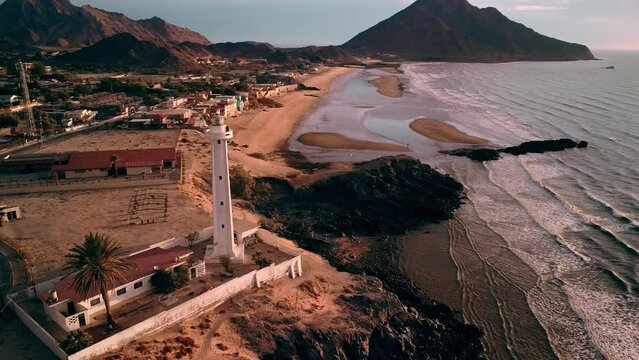 Aerial view of a lighthouse at the coast in San Felipe, Baja California Mexico, desert and sea, beach with waves at dawn