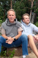 Portrait of young man son and his senior happy father walk together