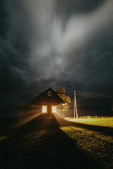 Fototapeta na wymiar Storm clouds over a cabin at night