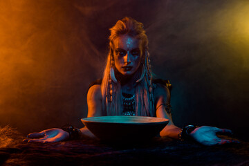 Portrait of viking druid woman interact otherworldly spirits demonic ritual orange light isolated...