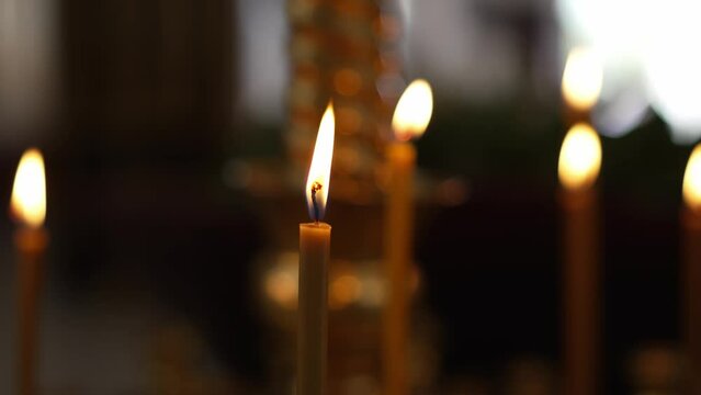 burning candles in the church on the altar.