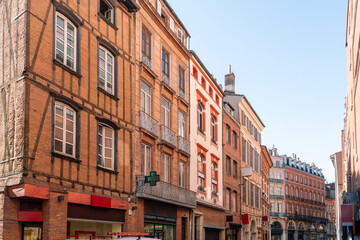 Facade or exterior of historic traditional houses in red or orange in the old city of Toulouse,...
