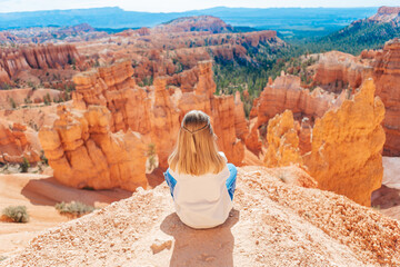 Little girl in Bryce Canyon hiking relaxing looking at amazing view during hike on summer travel in Bryce Canyon National Park, Utah, United States.