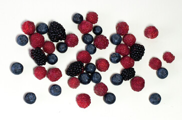 Ripe summer raspberry and blackberry isolated on white background.