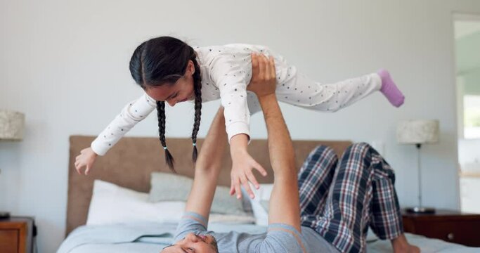 Father, girl and kid in home for airplane games, quality time and fun bonding in bedroom. Happy dad lifting child to fly for freedom, fantasy and trust of support, balance and laughing with energy