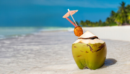 Tropical fresh coconut cocktail decorated plumeria on white beach. Summer vacation. Travel destinations. Long banner